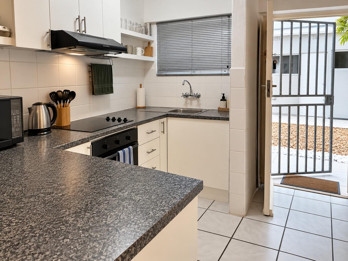 769370_Bright_Modern_Kitchen_with_Open_Courtyard_Door.jpg